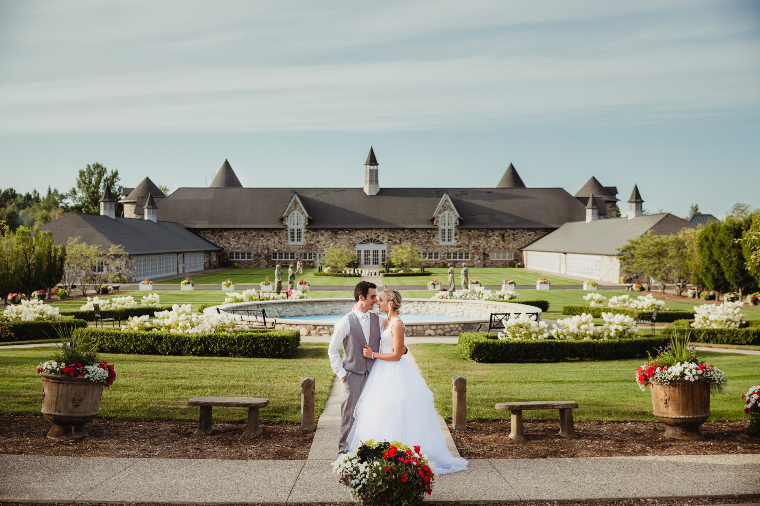 Bride and Groom standing close together outside the front of Castle Farms in Charlevoix Michigan