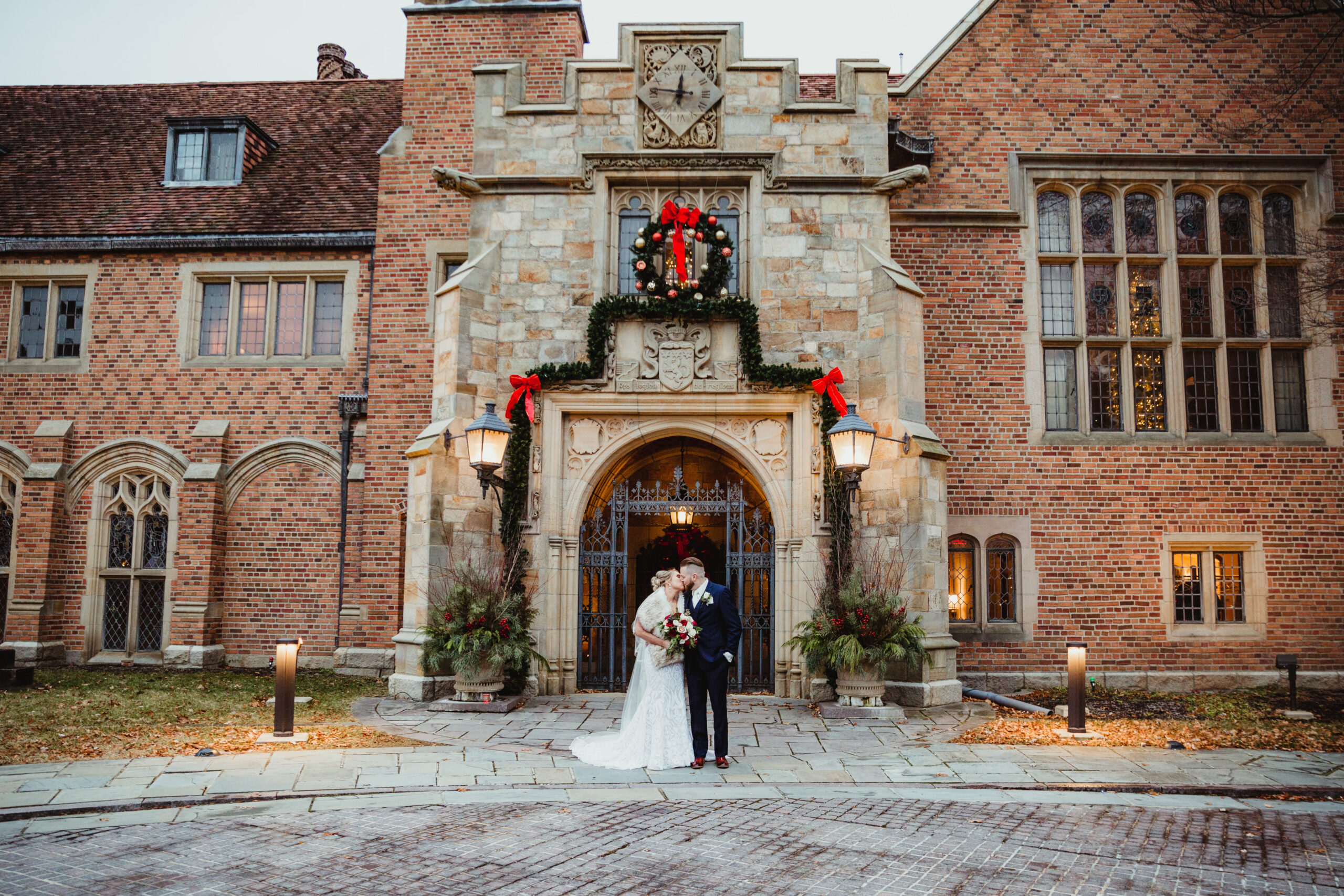 Kim + Jeff stand outside Meadowbrook Hall at Oakland University in Michigan where they just got married.